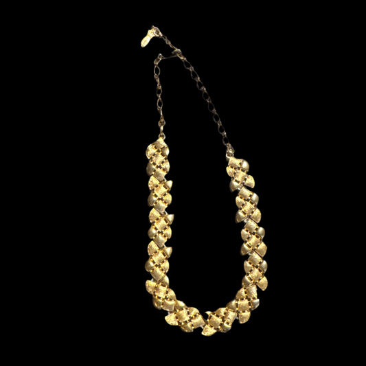 Vintage Emmons gold leaf necklace with textured heart-shaped links, featuring a chain and adjustable clasp, displayed against a black background. Only have 1 