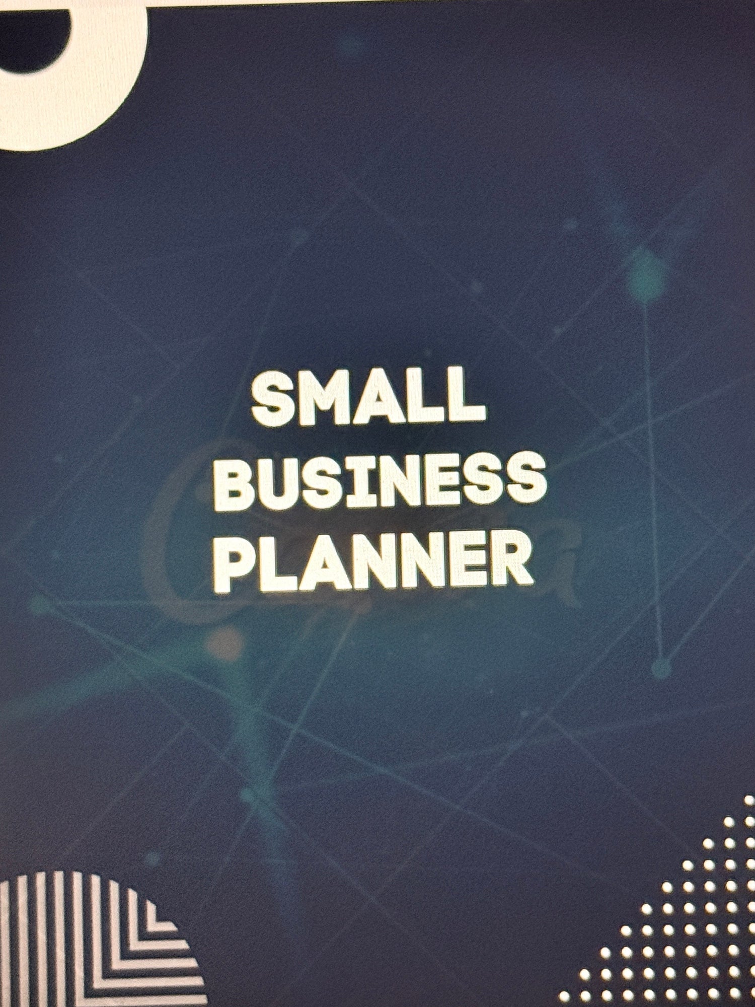 Small Business Planner book with geometric design on a beige background